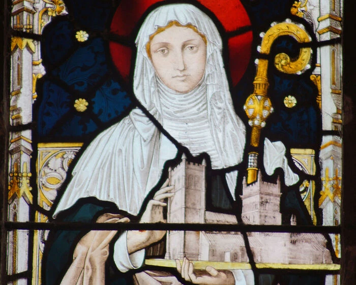 Detail of the stained-glass depiction of Cuthburga at Wimborne Minster.